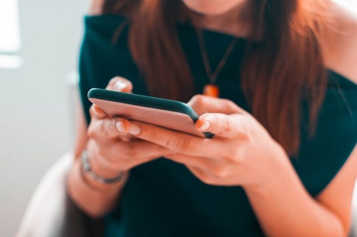 A young woman is using her smartphone